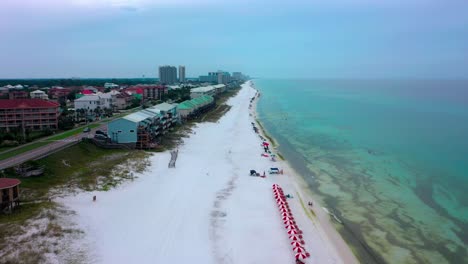 Drone-view-flying-up-the-beautiful-white-sand-beach-in-Miramar-near-Destin-Florida-with-great-views-of-the-gulf-of-Mexico