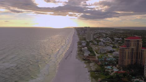 Beautiful-aerial-view-down-the-white-sand-beach-of-San-Destin-Florida-at-sunset