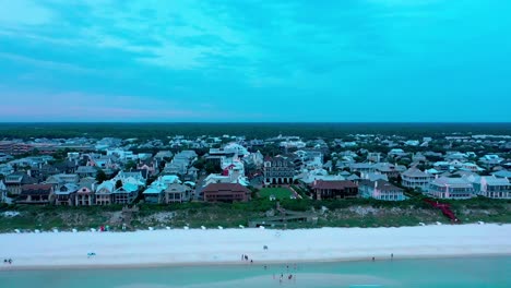 Drone-view-rising-shot-over-the-Gulf-of-Mexico-looking-towards-the-beach-in-Rosemary-Florida-during-golden-hour-sunset-with-lots-of-clouds