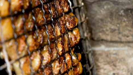 Fat-of-lamb-rib-sizzling-as-it's-barbecued-on-fire---close-up-view-of-grid