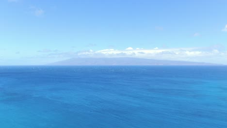 Aerial:-Hawaii's-deep-blue-ocean-horizon-looking-out-toward-Moloka'i-shrouded-in-vog