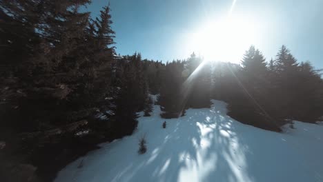Flying-FPV-up-the-side-of-a-snowy-mountain-dodging-between-the-trees