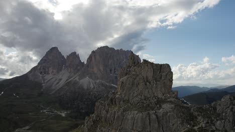 Parallax-drone-shot-of-a-person-on-top-of-the-mountain-at-Passo-Sella-in-Val-Gardena-Italy