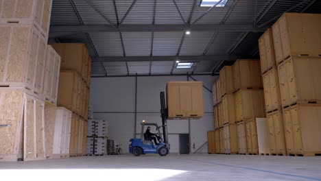 A-forklift-putting-away-one-of-the-big-wooden-boxes-in-his-stockpile-warehouse