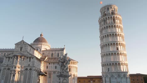 Establish-shot-of-cathedral,-statue-and-leaning-tower-of-pisa-on-the-pisa-square-in-the-morning-with-slider-or-gimbal-movement-in-tuscany-italy