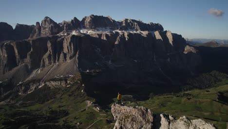 Drone-shot-of-a-person-on-top-of-the-mountain-at-Passo-Sella-in-Val-Gardena-Italy