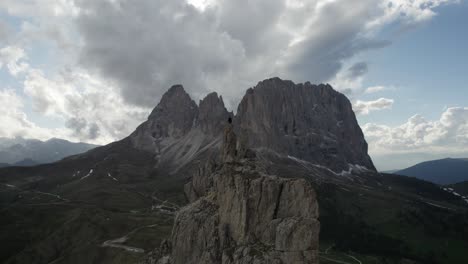 Drone-shot-of-a-person-on-top-of-the-mountain-at-Passo-Sella-in-Val-Gardena-Italy-1
