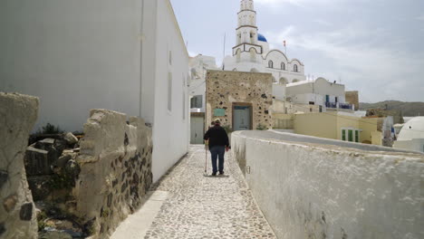 Following-an-elderly-man-walking-with-a-walking-stick-on-a-Greek-island