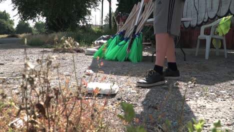 Conceptual-slow-motion-footage-young-boy-picking-garbage-in-Milan-suburbs
