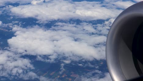 Engine-nacelle-visible-in-front-of-a-broken-undercast-layer-of-clouds