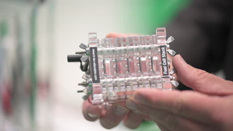Hands-holding-a-fuel-cell-stack-to-generate-electricity-from-hydrogen-and-air