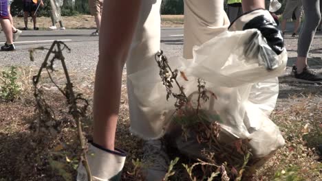 Volunteers-picking-trash-and-garbage-in-a-public-road-in-Milan-Italy