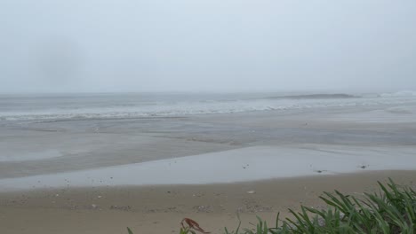 Dark-Rainy-Day-on-Sandy-Beach-During-Monsoon-Season-Ahead-of-Tropical-Storm,-Waves-Breaking-on-Shore
