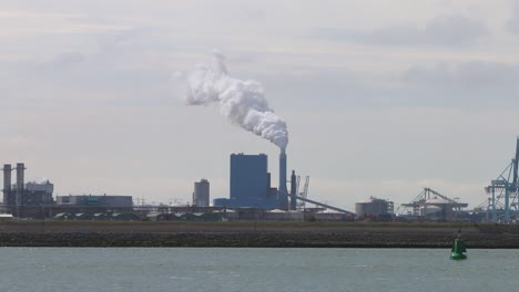 Looking-across-the-water-from-the-Hook-of-Holland-towards-factories,-chimney-and-docks-etc-1