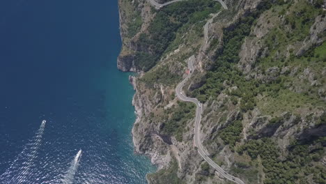 Bird's-eye-aerial-of-twisty-scenic-mountain-coastal-highway,-Italy