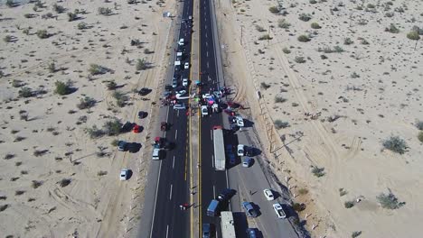 View-of-a-drone-descending-over-a-highway-during-a-manifestation-in-the-middle-of-the-road