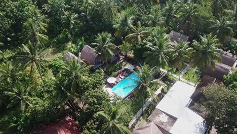 Aerial-orbits-swimming-pool-at-quaint-jungle-tourism-hotel-in-Lombok