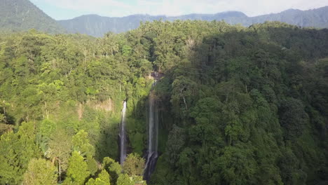 Aerial-flight-over-jungle-ridge-to-multi-cascade-waterfall-on-Bali-IDN