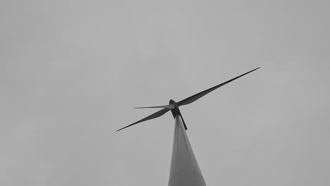 Low-angle-cinematic-shot-of-a-wind-turbine-creating-renewable-energy,-4K