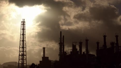 Industrial-shot-of-oil-refinery,-clouds-moving-in-the-background,-4K