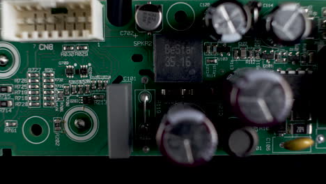 Close-Up-View-Of-Green-PCB-With-Transistors-And-Chips
