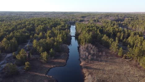 Push-in-drone-river-view-surrounded-by-forest-trees-at-golden-hour-Highlands06