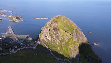Aerial-of-hikers-on-sunny-Reinebringen-overlooking-island-villages-in-Norway