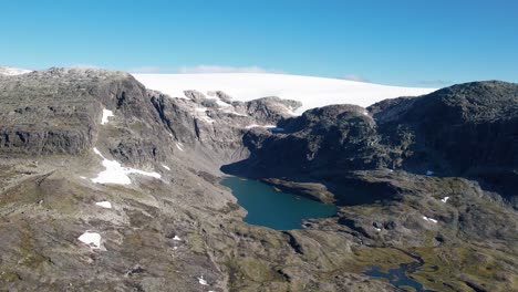 Glacier-lake-revealing-in-the-Hardangervidda-national-park-with-the-Hardangerjokulen-glacier-behind