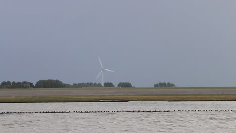A-Single-Wind-Turbine-turning-in-strong-wind-at-the-edge-of-the-Wadden-Sea