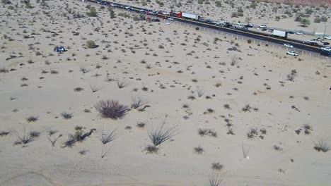 View-of-a-drone-flying-away-from-a-highway-in-the-middle-of-the-desert