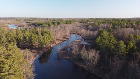 Push-in-drone-river-view-surrounded-by-forest-and-trees-at-golden-hour-Highlands03
