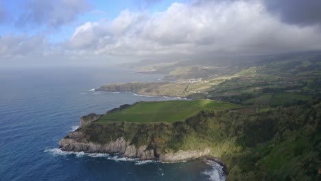 Storm-clouds-casting-shadow-on-Azores-coastline-headlands,-aerial