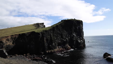 Stunning-panning-shot-of-Iceland's-giant-coastal-cliffs