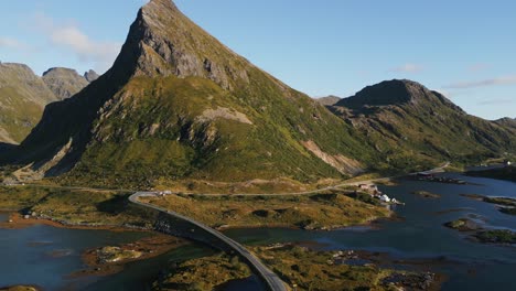 Rotating-movement-from-the-Fredvang-Lofoten-road-bridge-towards-the-green-grass-covered-mountain-peak-in-Lofoten-Islands-Norway-in-Northern-Europe