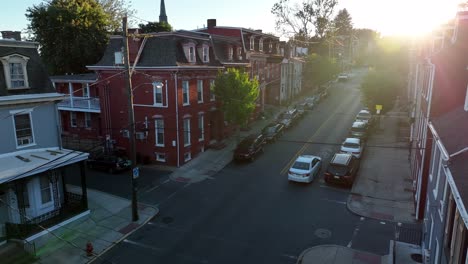 Car-driving-down-an-urban-neighborhood-street