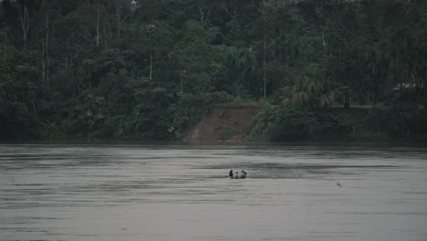 People-Sailing-In-Calm-River-Near-The-Village-At-The-Amazon-Forest-Mountain-In-Ecuador