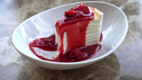 Vanilla-crepe-cake-with-raspberry-and-strawberry-sauce-on-plate