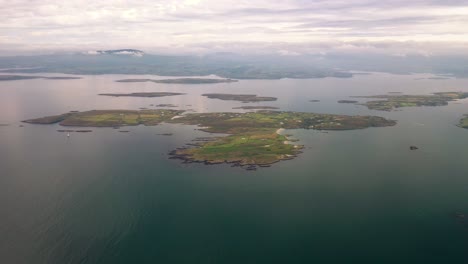 Aerial-360-degree-view-of-Roaringwater-Bay-from-high-above-with-Sherkin-Island,-Cape-Clear,-Hare-Island,-Baltimore,-The-Beacon,-Spanish-Island,-Castle-Island,-Schull-in-distance