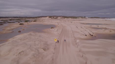 People-Walking-On-Sandy-Trail-Near-Stockton-Beach-In-The-Hunter-Region-Of-New-South-Wales,-Australia