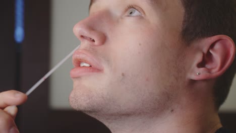 Young-Man-At-Home-Uses-Nasal-Swab-To-Self-test-For-Covid-19