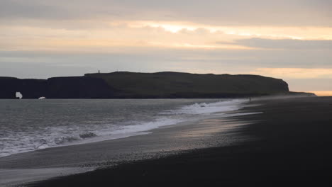 Gorgeous-wide-shot-of-waves-crashing-on-shore-at-the-Reynisfjara-Black-Sand-Beach,-Iceland