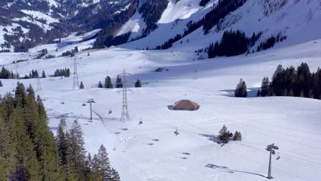 Aerial-Shot-under-the-Brienzer-Rothorn-in-Sörenberg-Ski-Resort-with-Snow-in-Winter---Top-Destination-for-Families-in-UNESCO-Biosphere-Entlebuch-|-Switzerland-by-drone