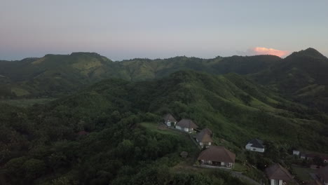 Aerial-flight-past-hilltop-villas-on-tropical-island-of-Lombok,-IDN