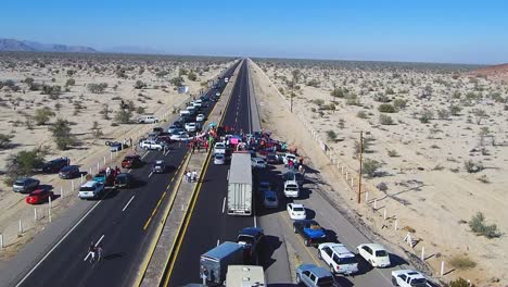 View-of-a-drone-flying-over-a-highway-to-a-manifestation