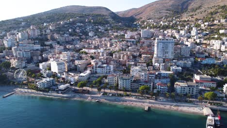 AERIAL-Orbiting-Shot-of-Sarande,-Albania-and-the-Turquoise-Beach