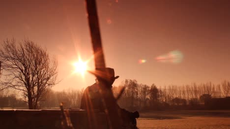 Cowboy's-Silhouette-in-the-Winter-Wonderful-Landscape-during-Golden-Brown-Sunrise