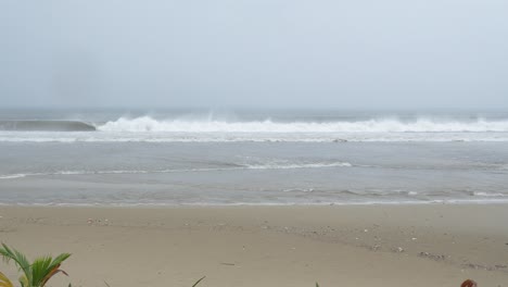 Rough-Sea-Waves-on-Dark-Rainy-Day-During-Monsoon-Season-Breaking-on-Sandy-Beach