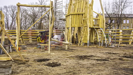 Static-shot-of-workers-construction-busy-constructing-wooden-kids-playground-in-timelapse-on-a-cloudy-day