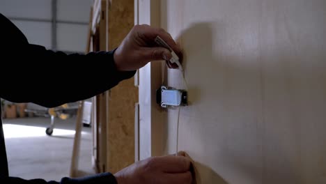 Handheld-close-up-shot-of-a-man-putting-a-security-tag-on-the-storage-locker