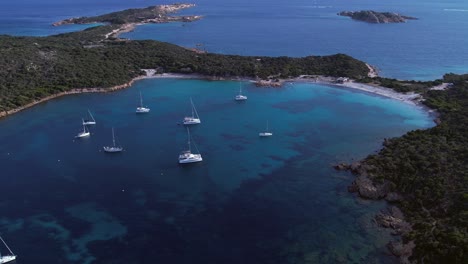 Expensive-yachts-moored-in-emerald-colored-bay-on-Caprera-Island,-Sardinia,-Italy
